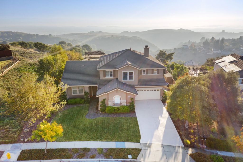 aerial photo of large house and lawn in a neighborhood in california