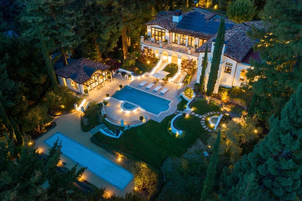 full view of mansion property using aerial drone photo